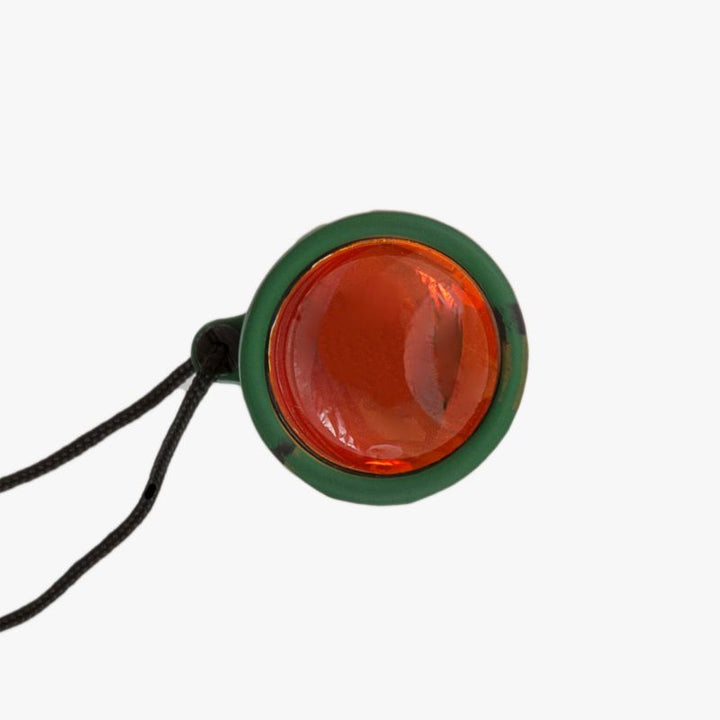 highlander forces dales monocular. green rubber cased cylindrical monocular red lens front on
