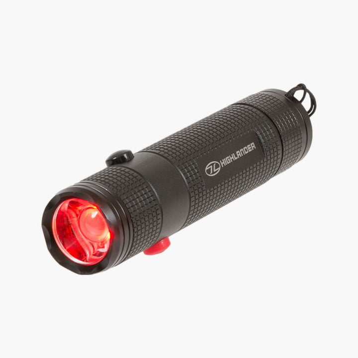 highlander hawkeye torch demonstrates full beam red light. top black button near bulb and red button on bottom. Square pattern grip covers casing
